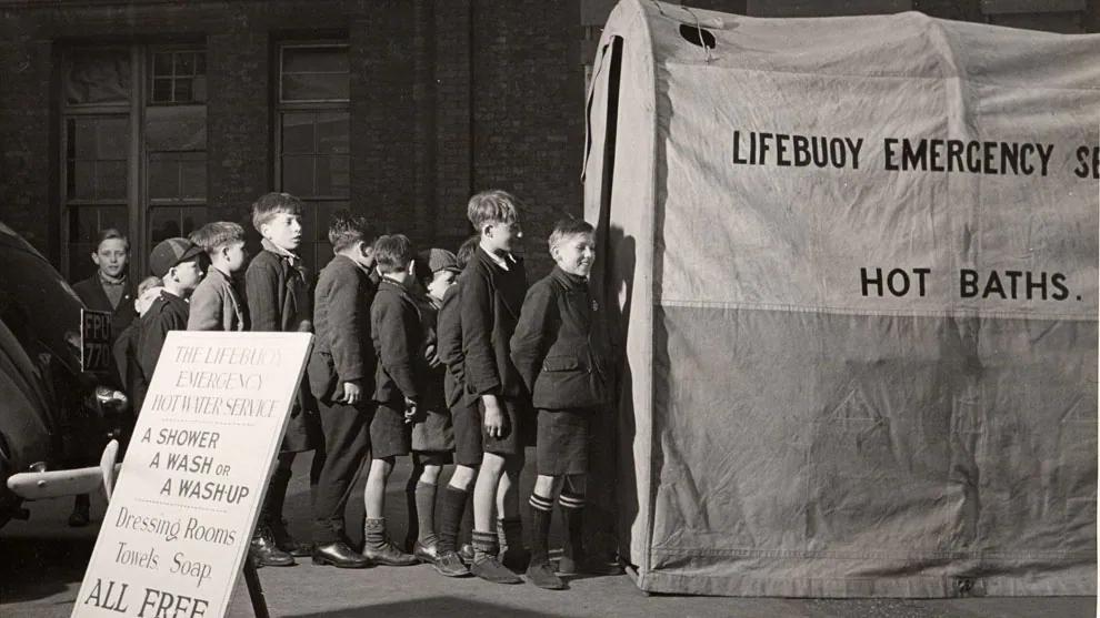 Children queueing for the Lifebuoy emergency hot water service