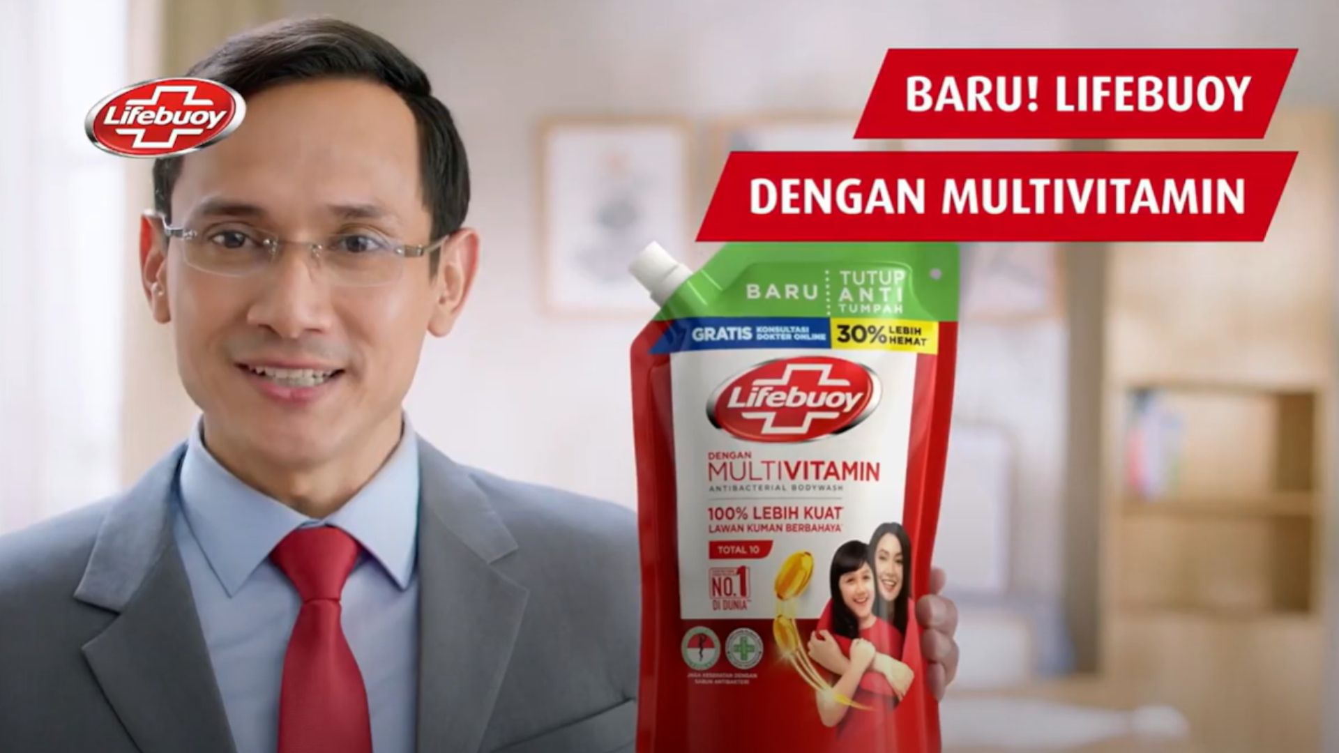 A man wearing a suit and tie holding a pouch of Lifebuoy Multivitamin. There is a Lifebuoy logo in the top corner.