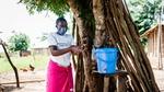 Woman washing her hands outdoors