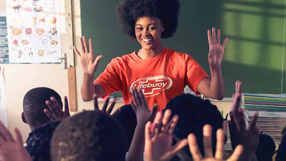 A teacher wearing a Lifebuoy t-shirt in class