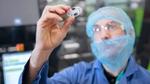 Unilever scientist inspecting a deodorant packaging component made from recycled plastic
