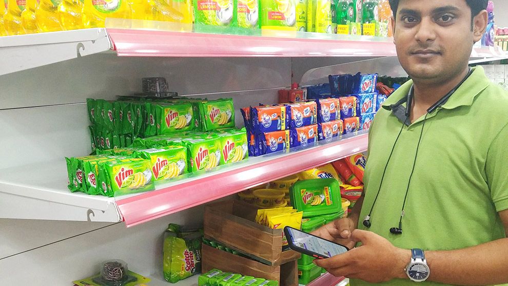 Retailer using app on a smartphone to check stock