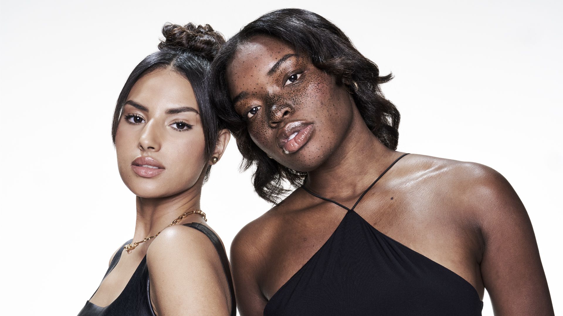 Two women with dark brown hair posing for a photo. 