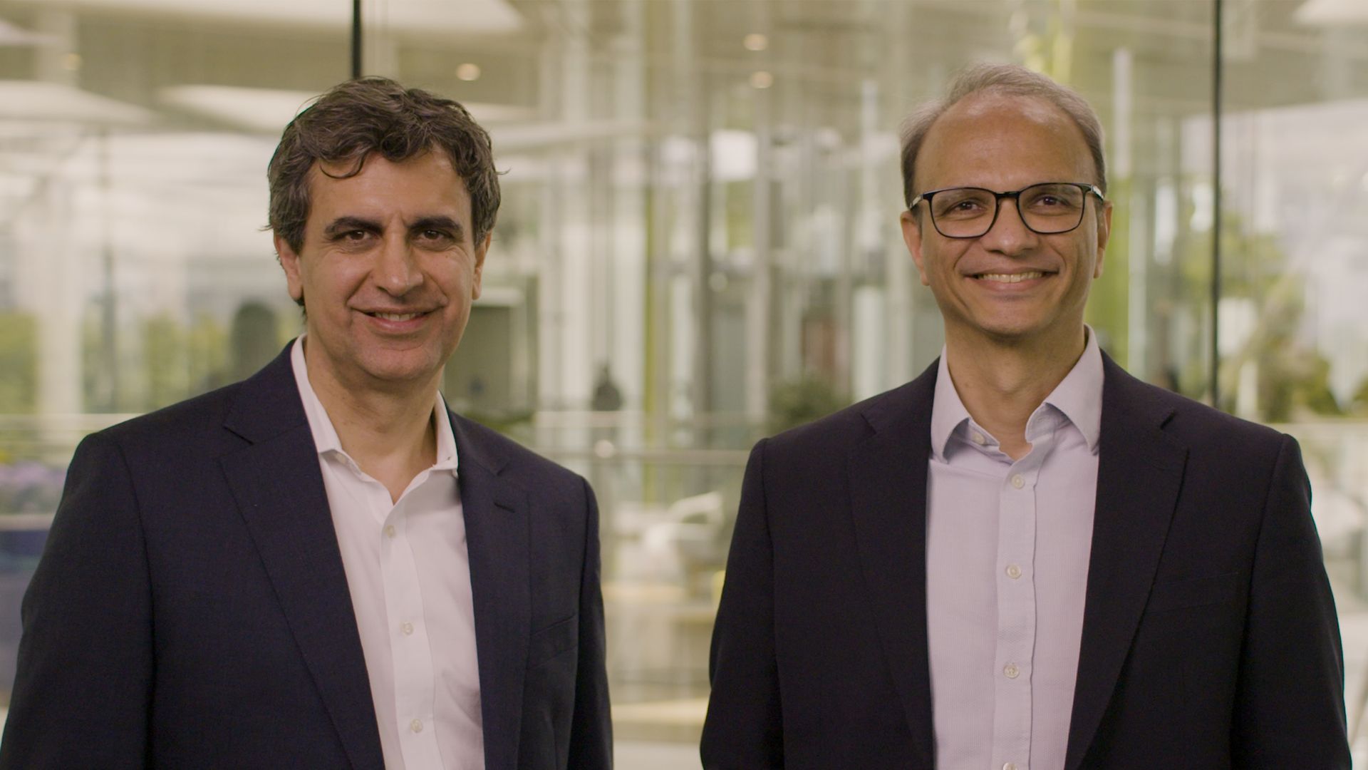 Fernando Fernandez, Unilever’s Chief Executive Officer, standing on the left and Srinivas Phatak, Unilever’s acting Chief Financial Officer, standing on the right. Both are wearing dark suits with light coloured shirts. 