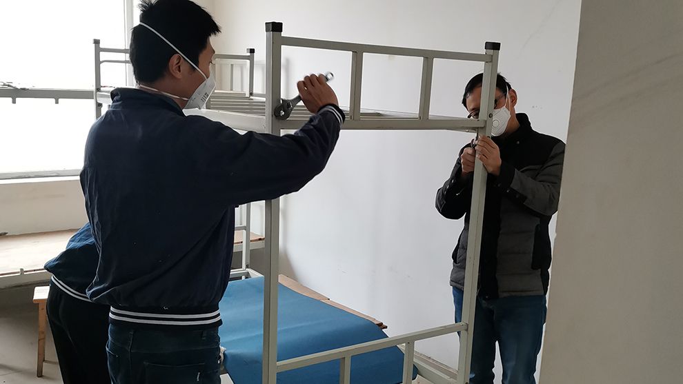 Image of two men putting up a bunk bed