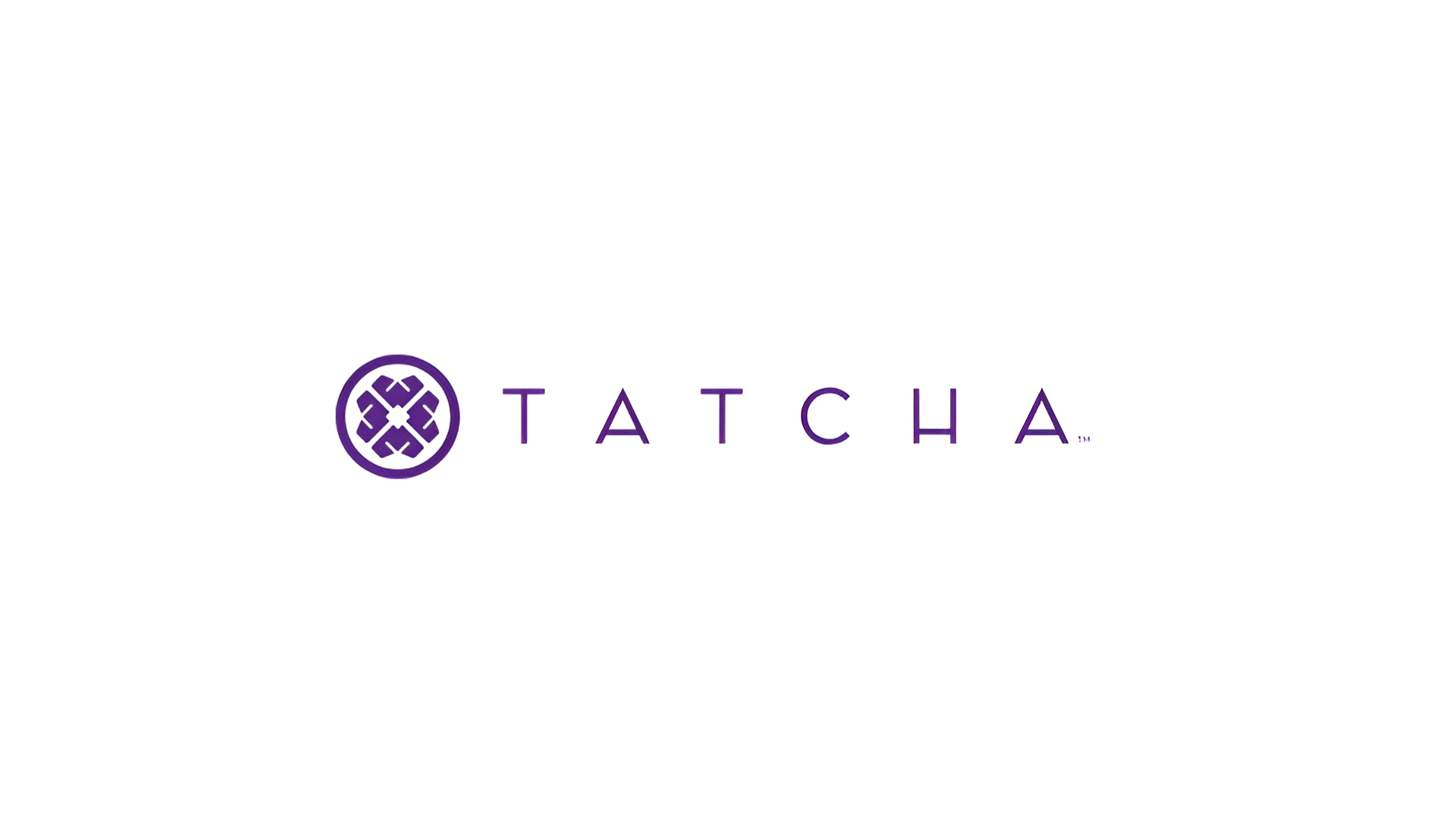 The logo for Unilever Beauty & Wellbeing’s Tatcha brand. Purple text reading ‘Tatcha’ with a Japanese-inspired flower 