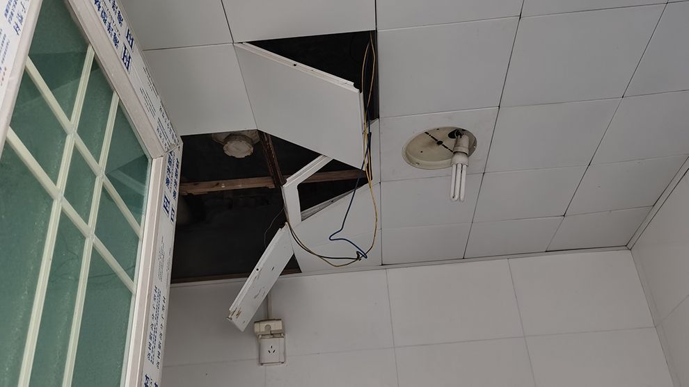 Image of broken ceiling and loose tiles