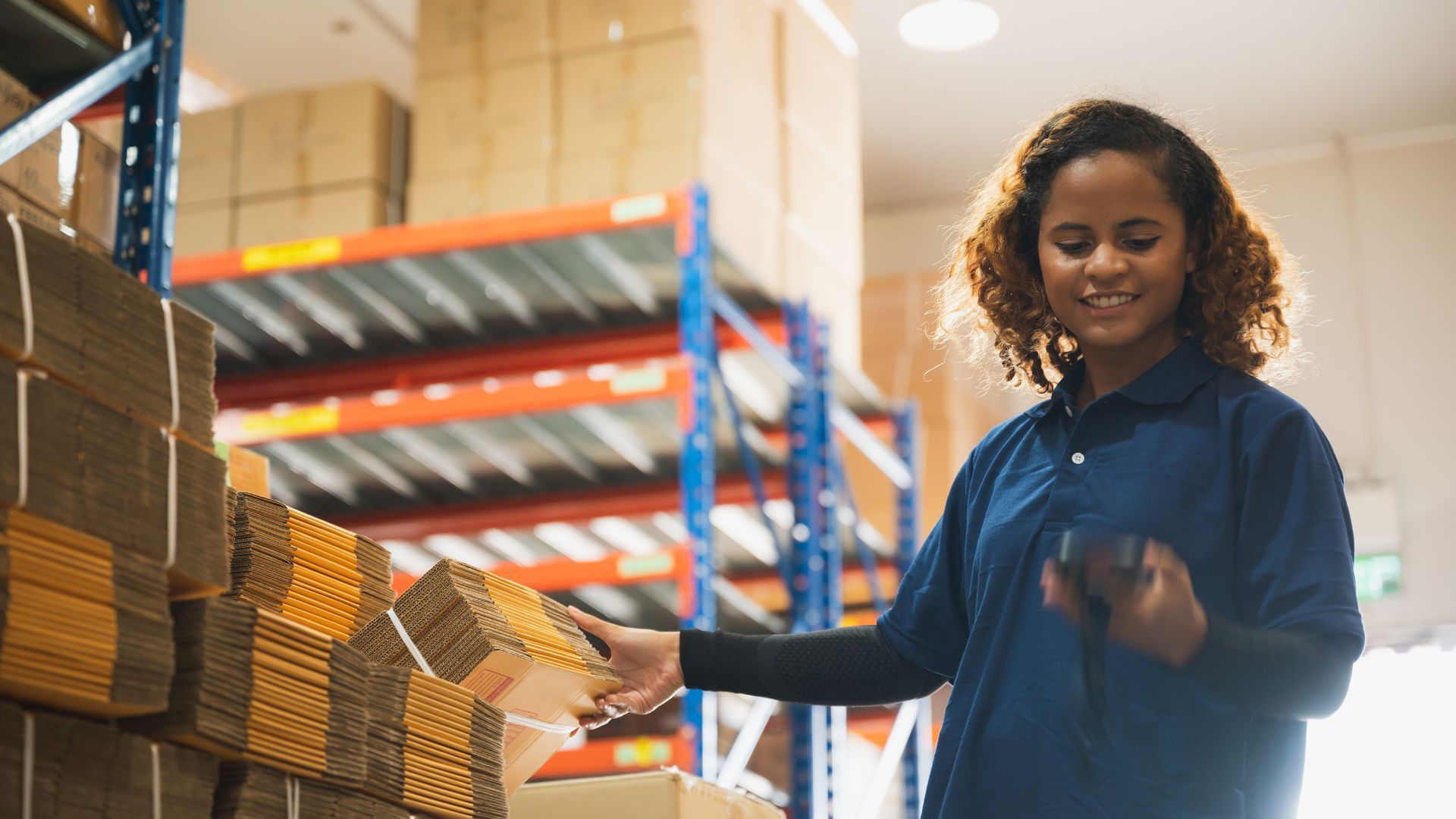 An employee working in a packaging warehouse