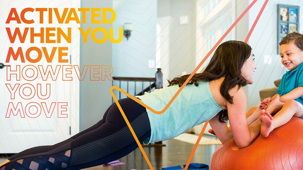 a woman working out at home with her young child