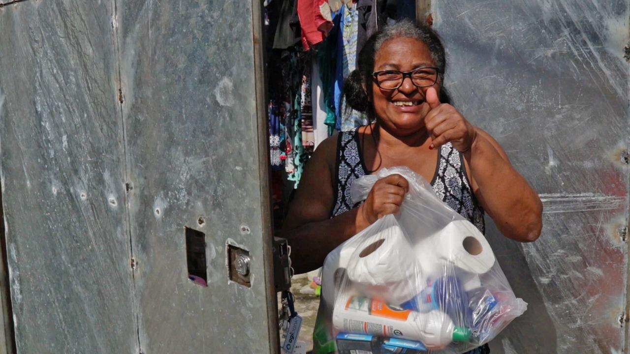 Woman receiving a donation with a cheerful thumbs-up