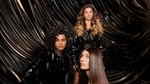Three women with shiny hair, one blonde waves, one dark curls, one dark glossy. Photo is an ad for TRESemmé Lamellar Shine.