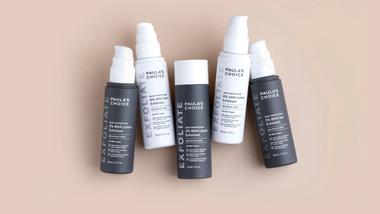 Five products from the Paula’s Choice range including AHA and BHA Liquid Exfoliants. Products are dark grey and white.