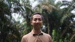 Rauf Prasodjo, Senior Manager for Sustainable Sourcing at Unilever in a palm-oil forest looking front on wearing a brown t-shirt.