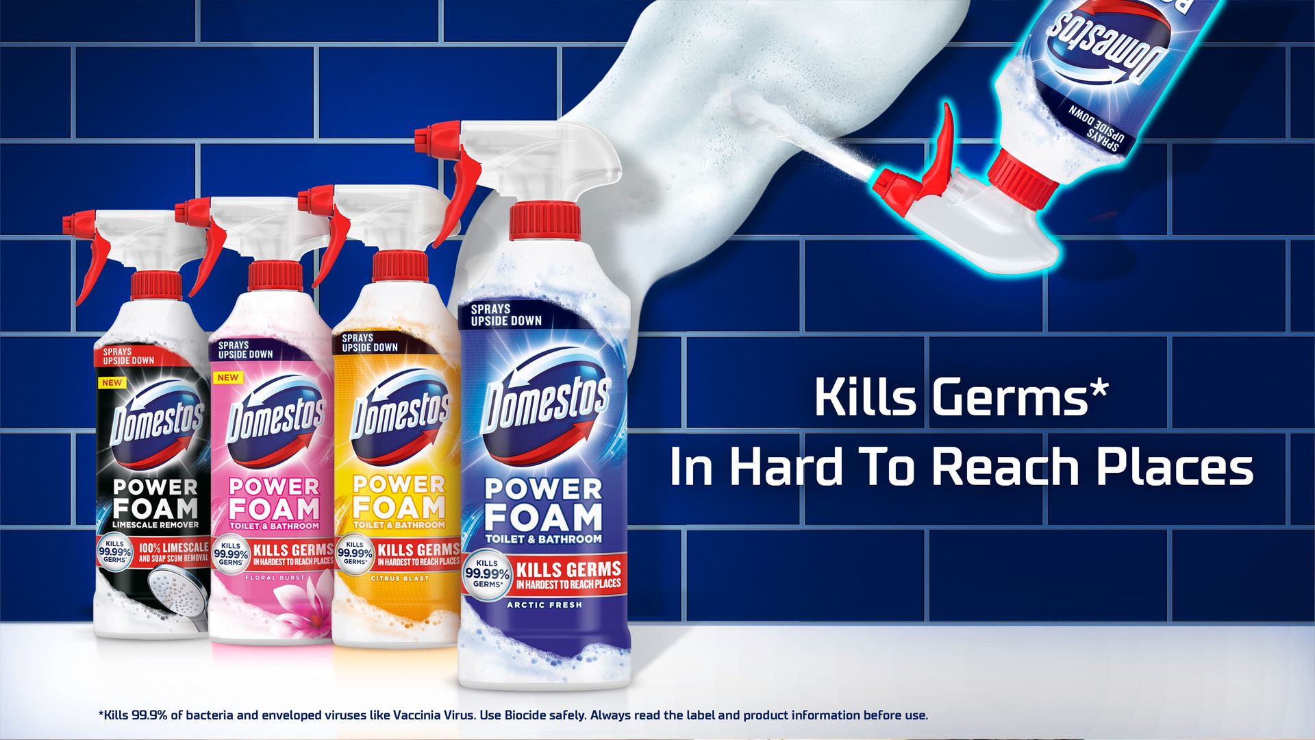 An ad showing a row of four Domestos Power Foam bottles on a white counter in front of a blue-tiled wall. Next to them is an upturned bottle with Power Foam being sprayed from the bottle onto the wall.