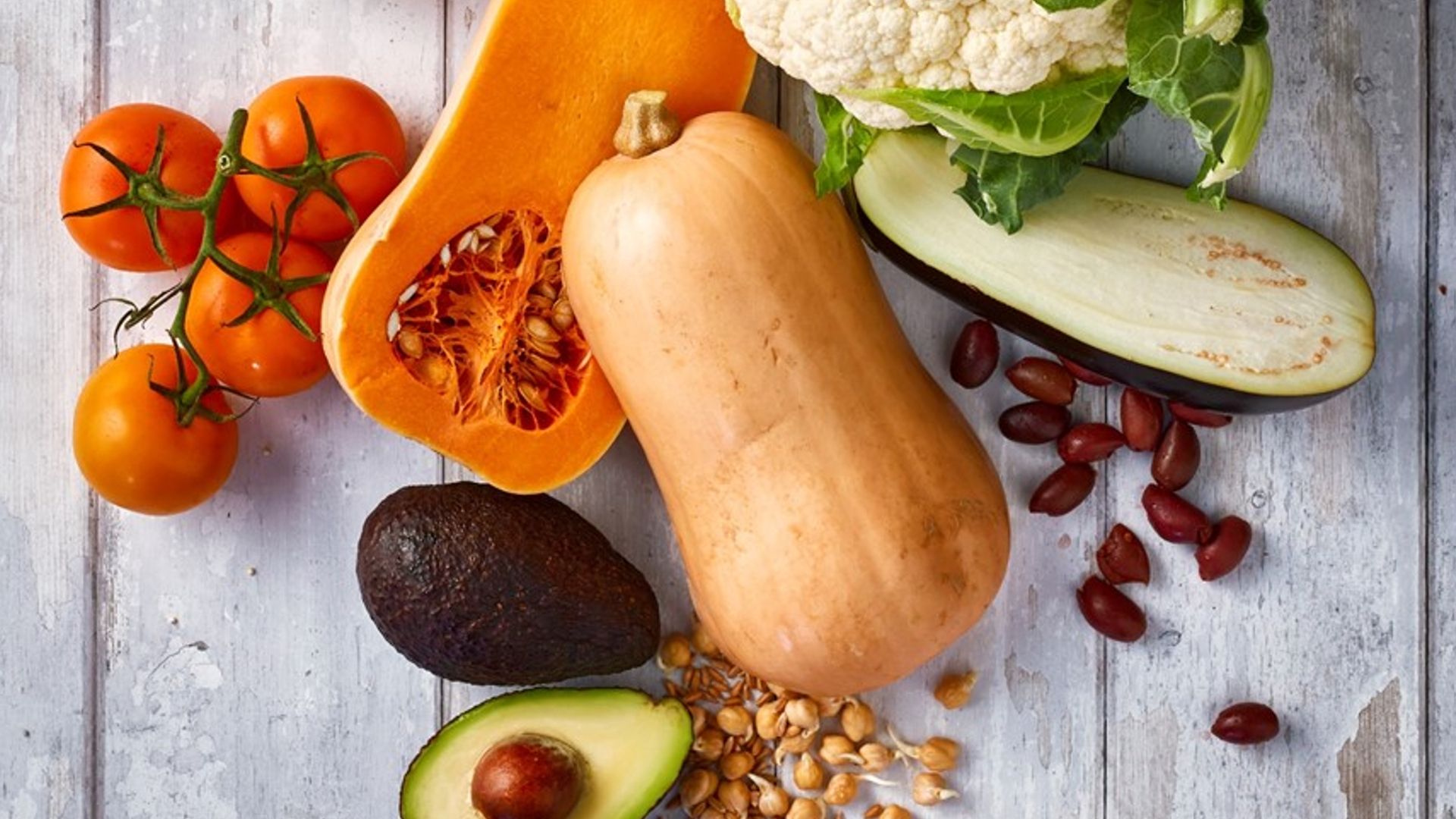 A selection of food including cauliflower, butternut squash and bread 