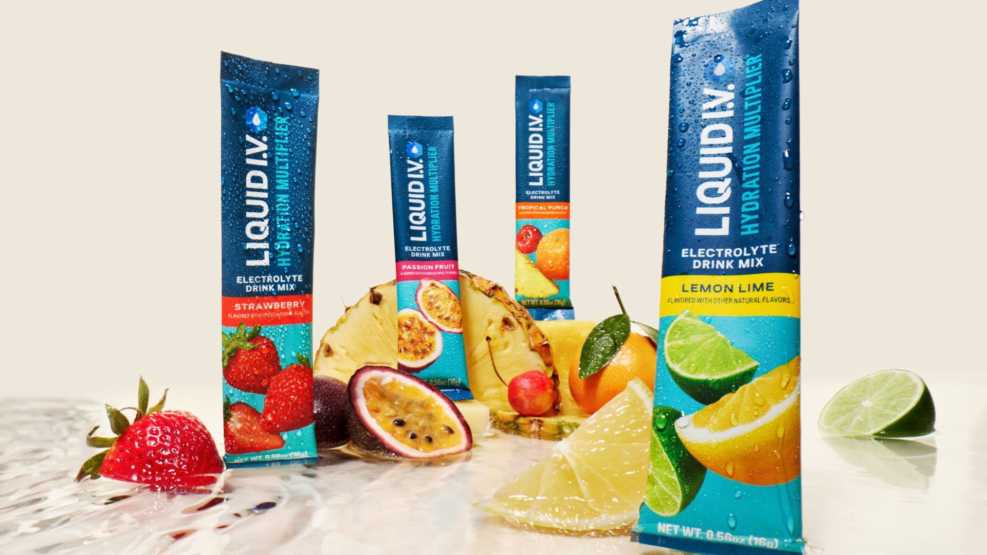 Four sachets of Liquid I.V. surrounded by various fruits.