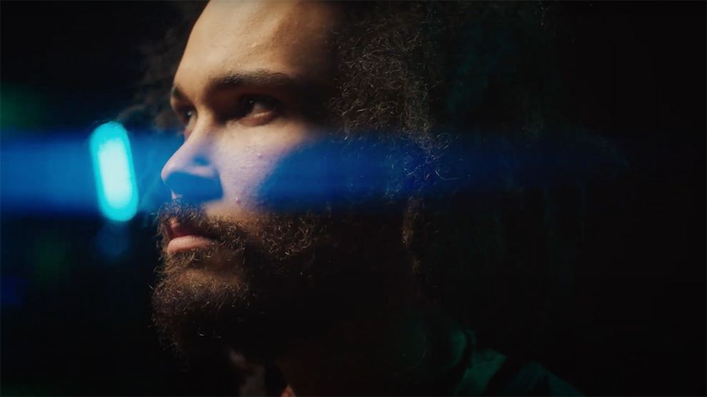 Side-on close up of a man's face who has a stern expression 