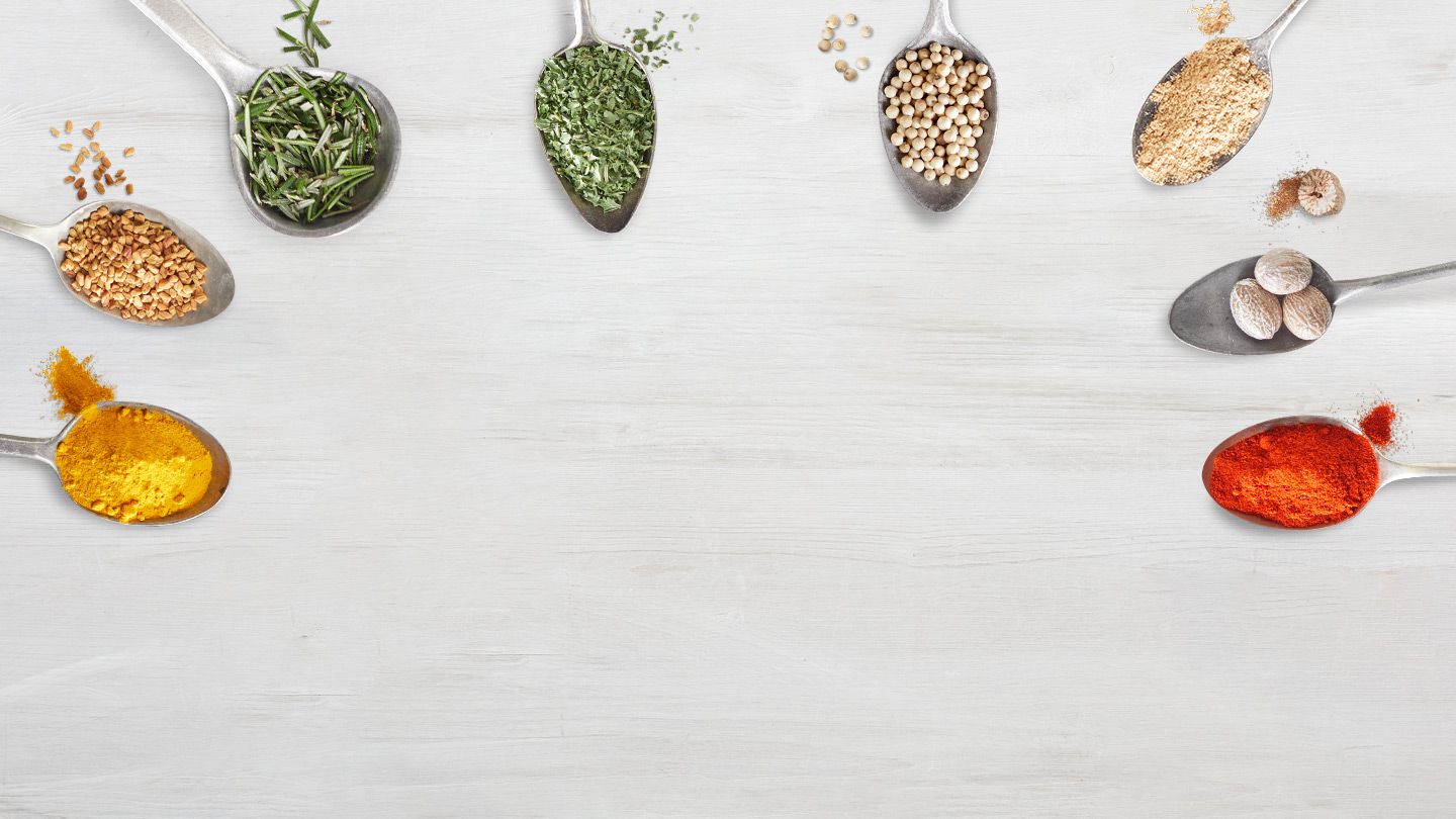 a semi-circle of 8 spoons filled with spices