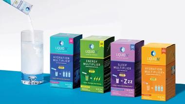 Four products from the Liquid IV range, part of Unilever’s Beauty & Wellbeing portfolio. A hydration powder is being added to a glass of water.