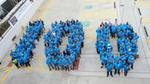 The factory team at Kilbourn, US, line up to form the number 100 as part of the centenary celebrations