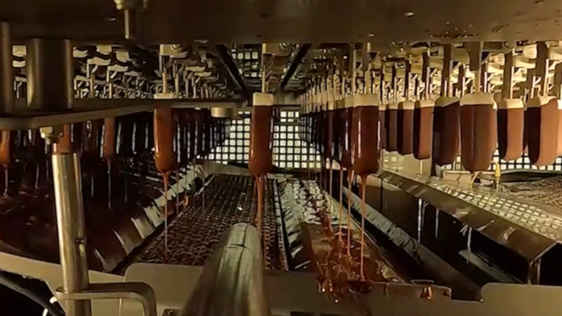 Magnum ice creams being dipped on the factory production line