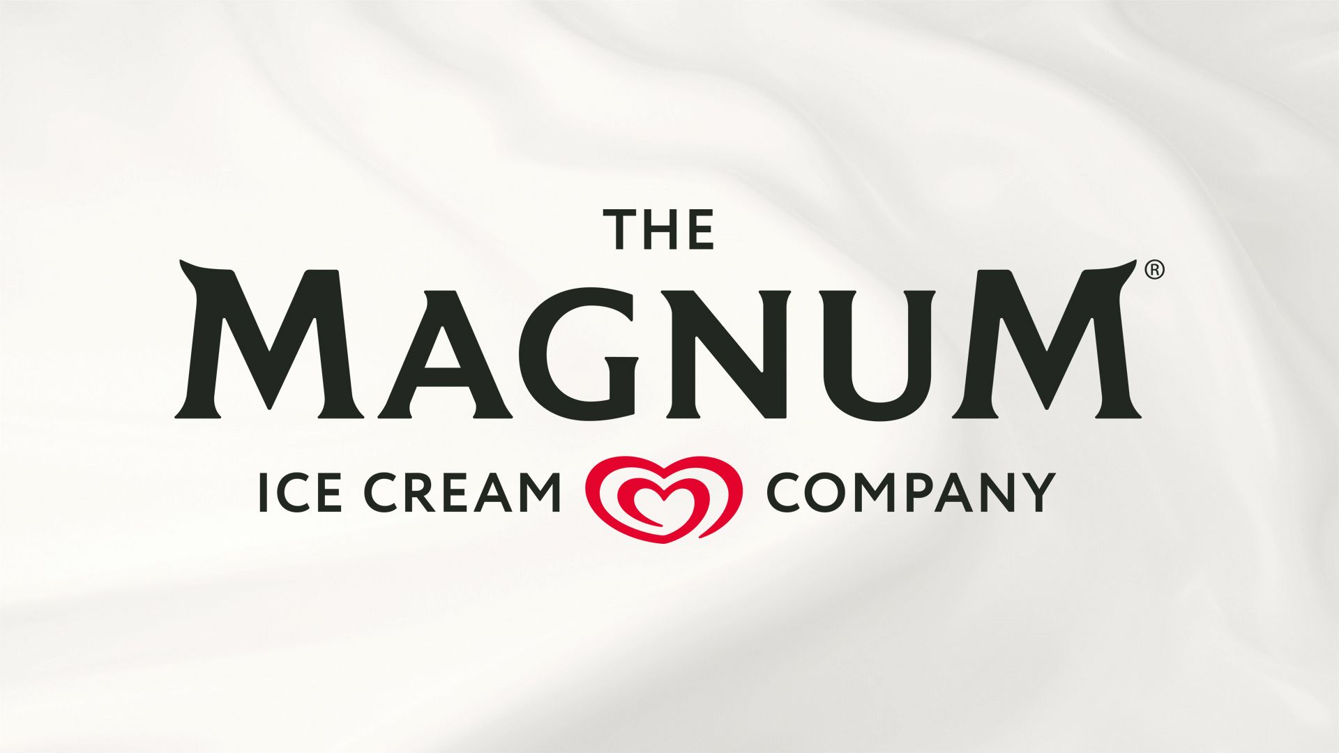 Logo of The Magnum Ice Cream Company with a red stylized heart between the words 'ICE CREAM' and 'COMPANY', set against a textured background.