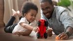 Boy and father playing with toy car