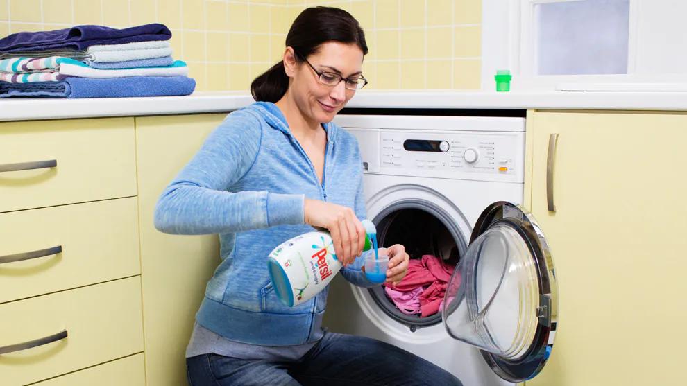 A woman using Persil with her washing